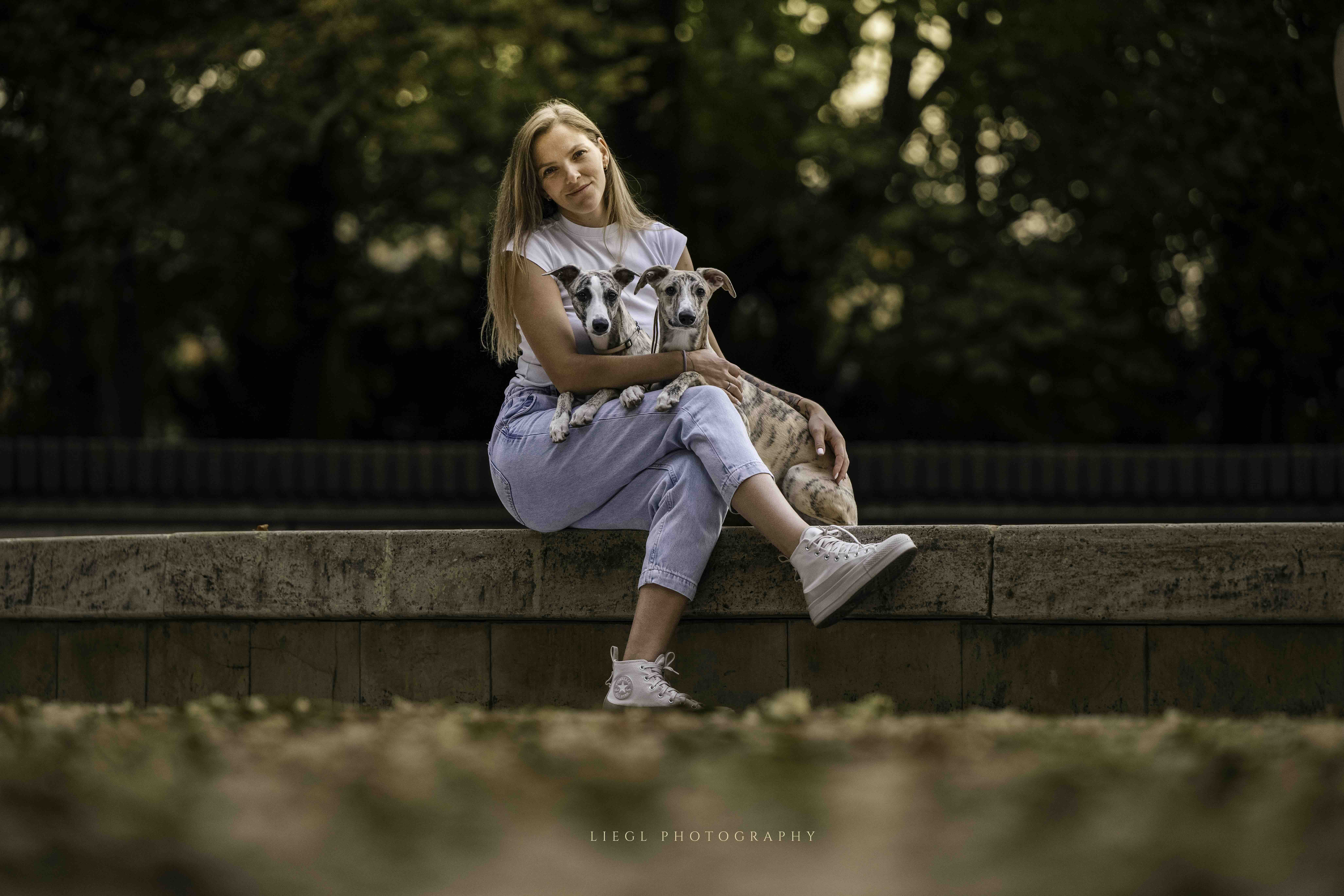 Petra Máťušová holding two whippet puppies