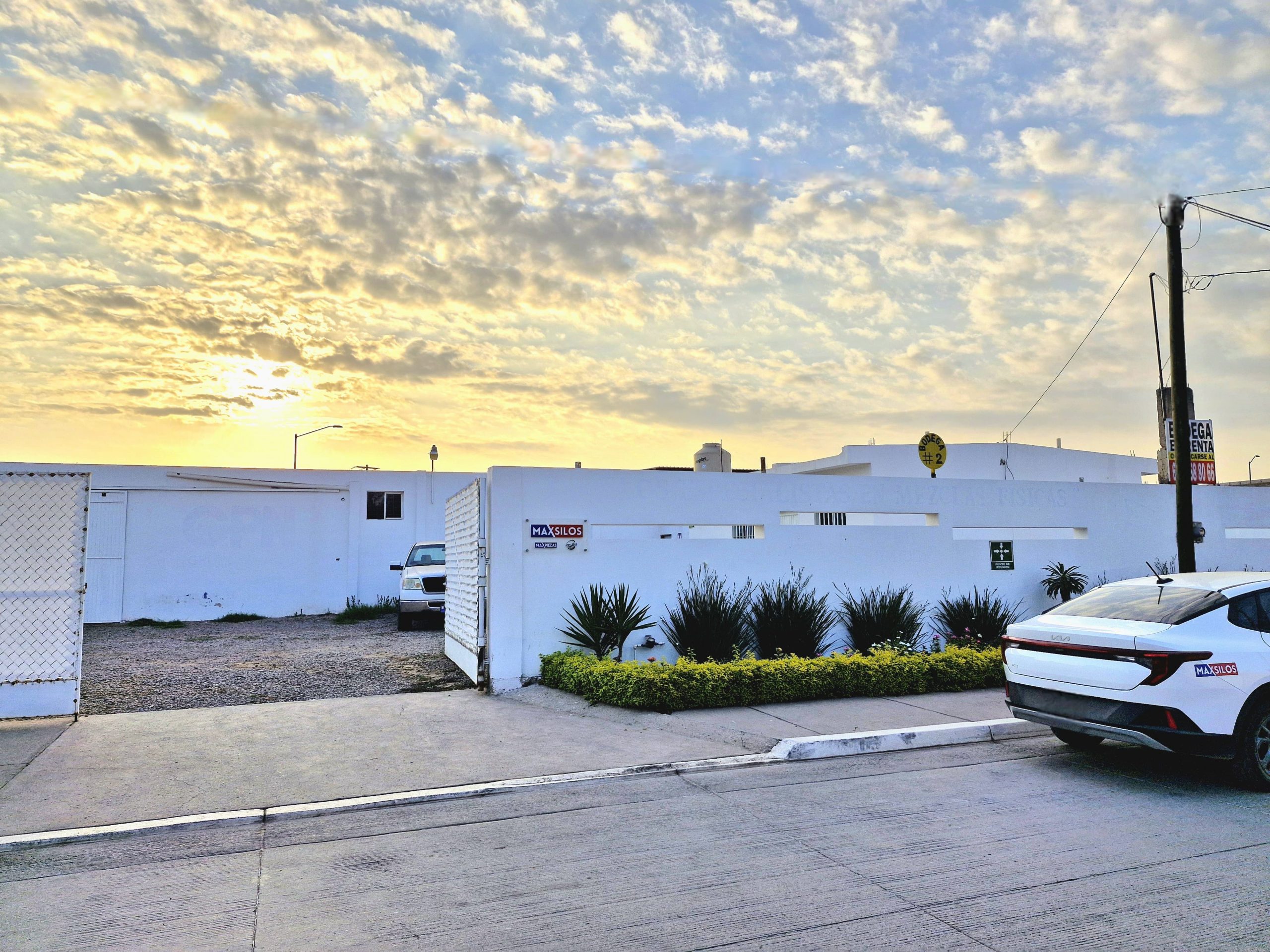 a white building with a few cars parked in front of it