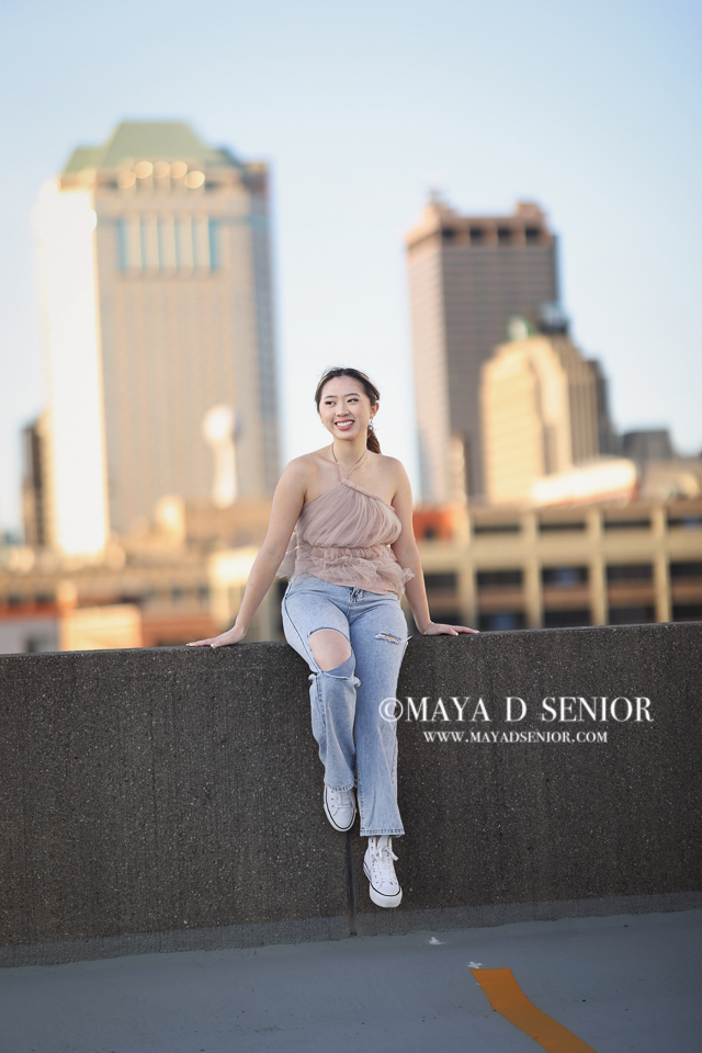 High school senior portrait in a downtown urban setting in Columbus, Ohio, with city buildings in the background.