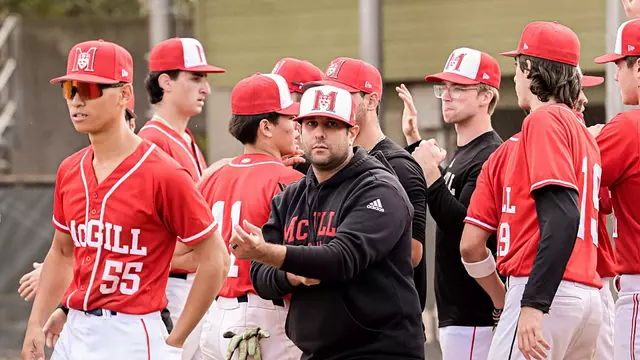 The image depicts a group of baseball players and their coach, all dressed in red and white uniforms, gathered together on...