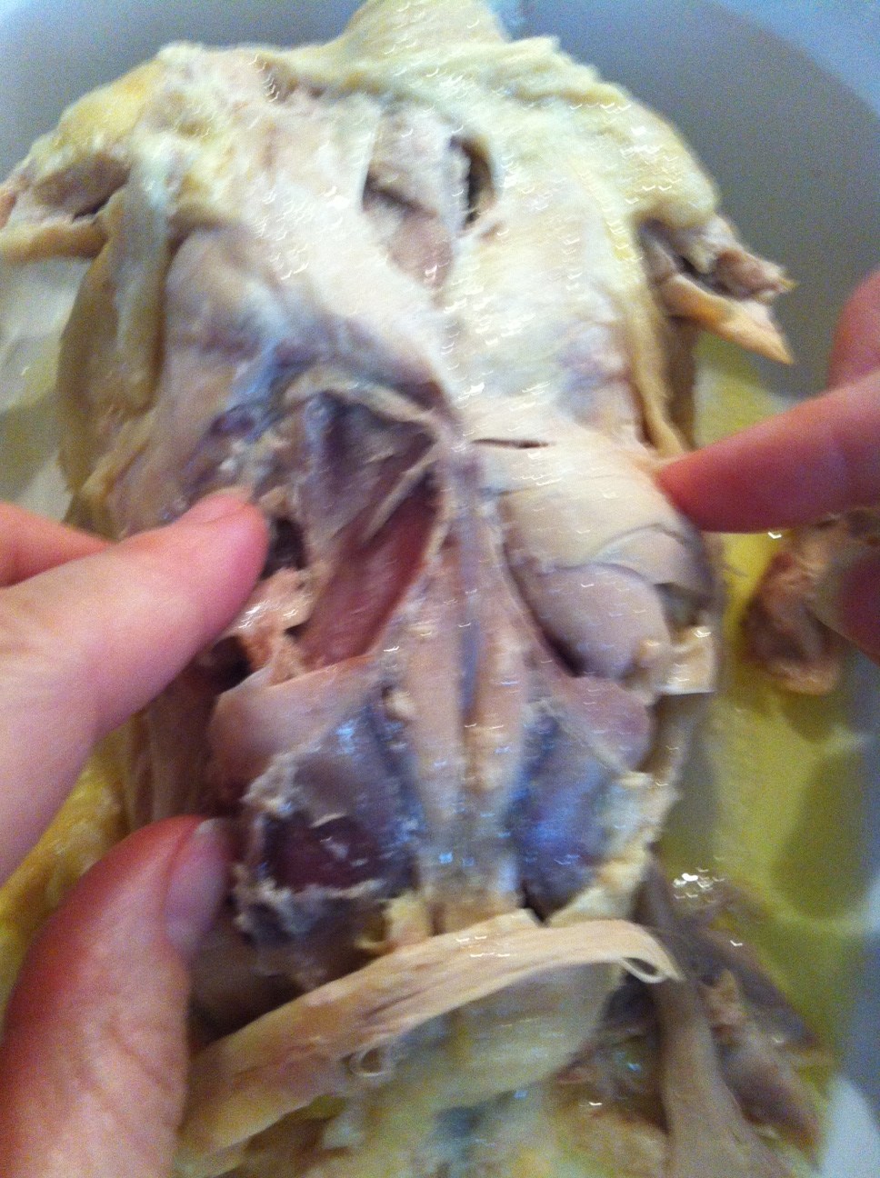 Removing the oysters on a poached chicken