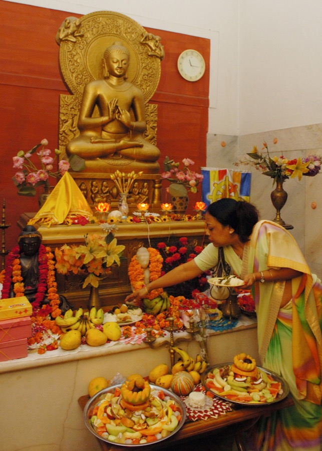 Devotee worshipping Buddha during Buddha Purnima