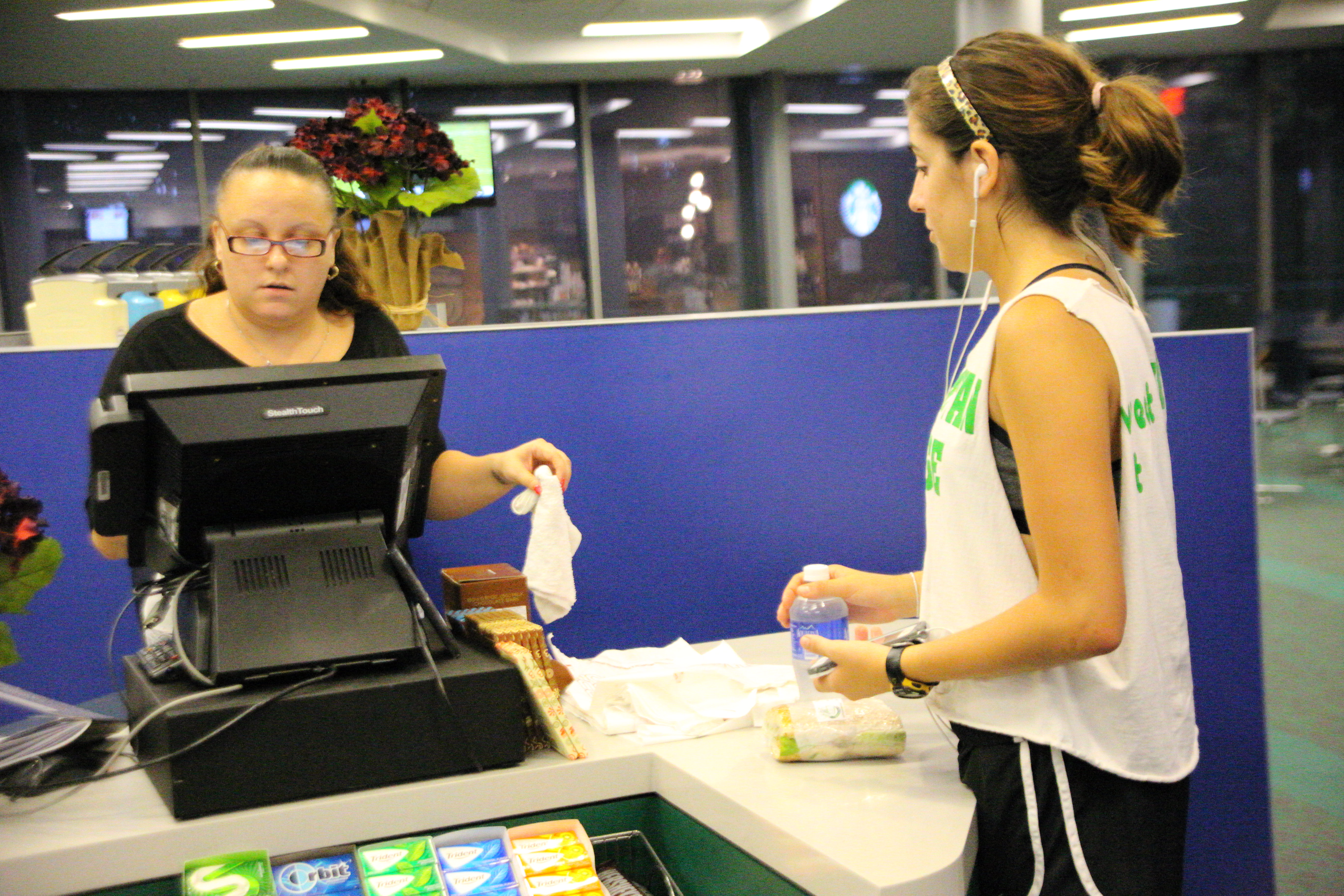 Student Johanna Petruski buys food in the commons marketplace. The marketplace has drawn large crowds at lunch time - and confusion - as many students were unaware of meal swipe options there until late last week. Photo by James O'Connor.