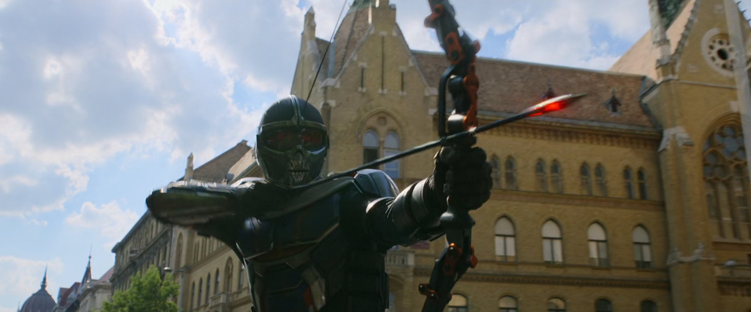 Taskmaster readies a bow and arrow to fire.