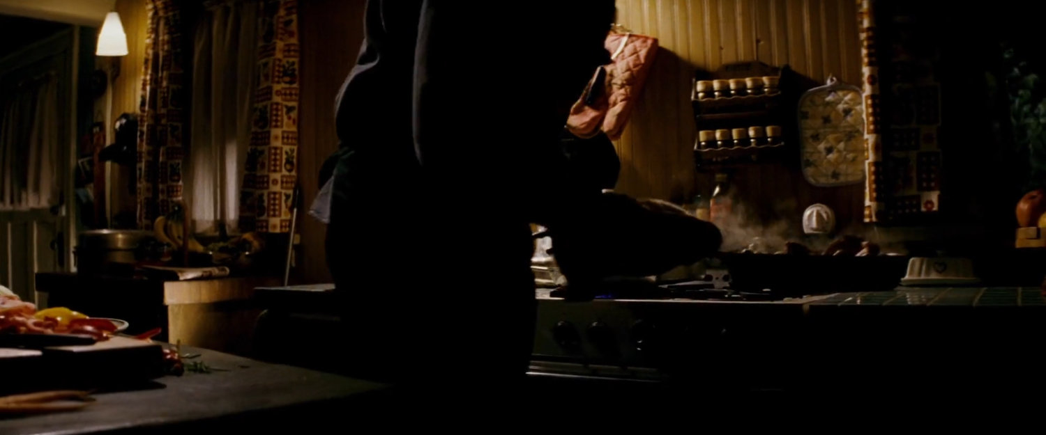 Mark Miller cooking inside his cabin.