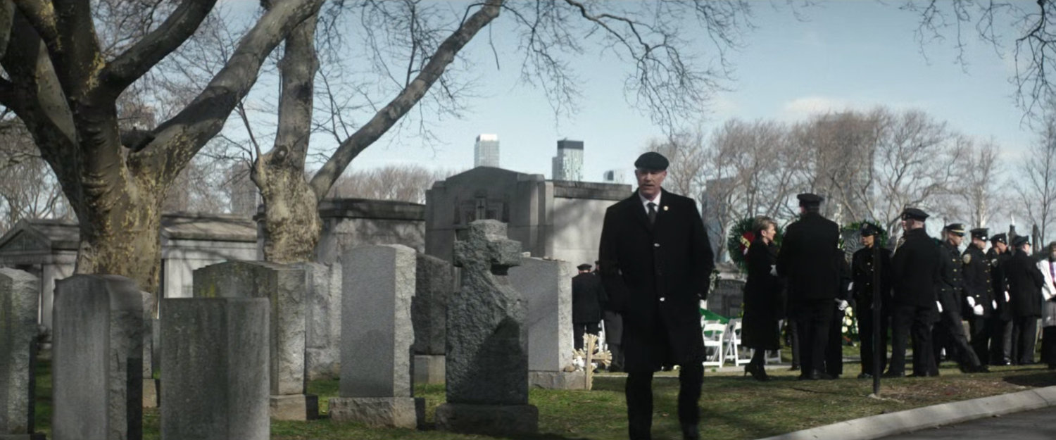 Chief Gallo walking across cemetery.