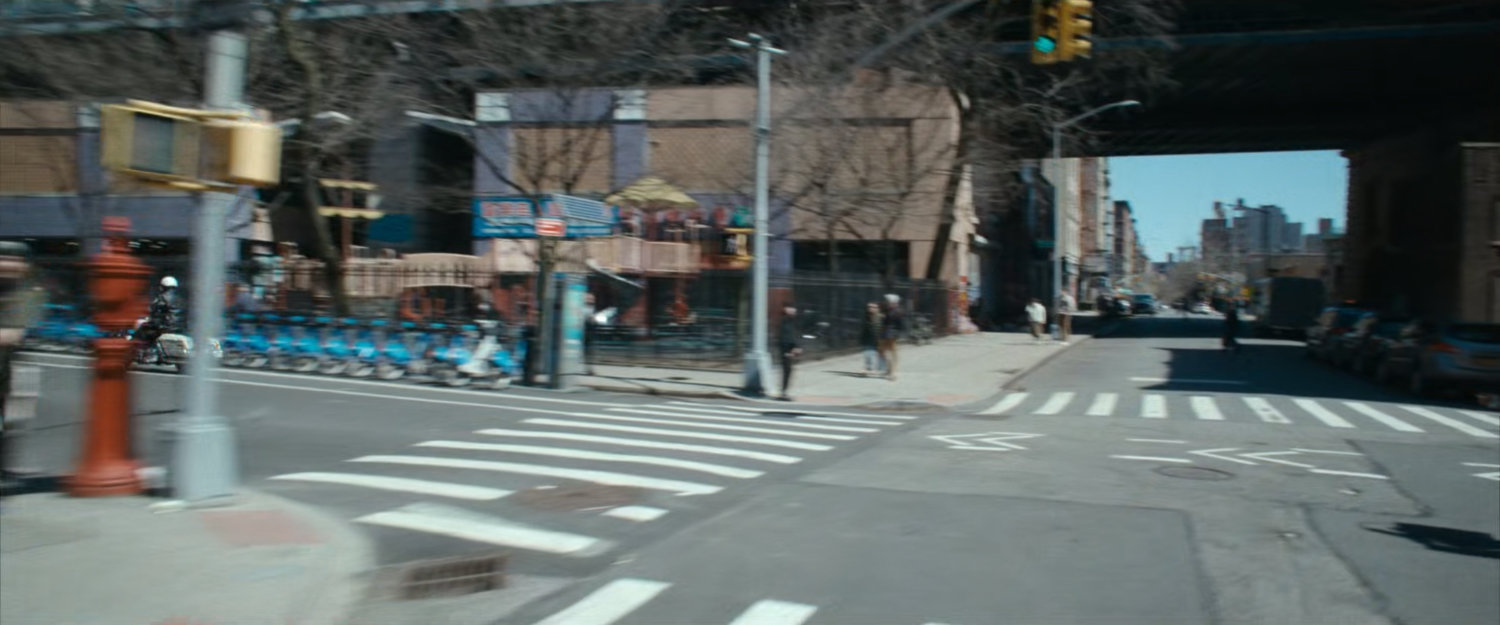 Motorcycle officer speeding past intersection.
