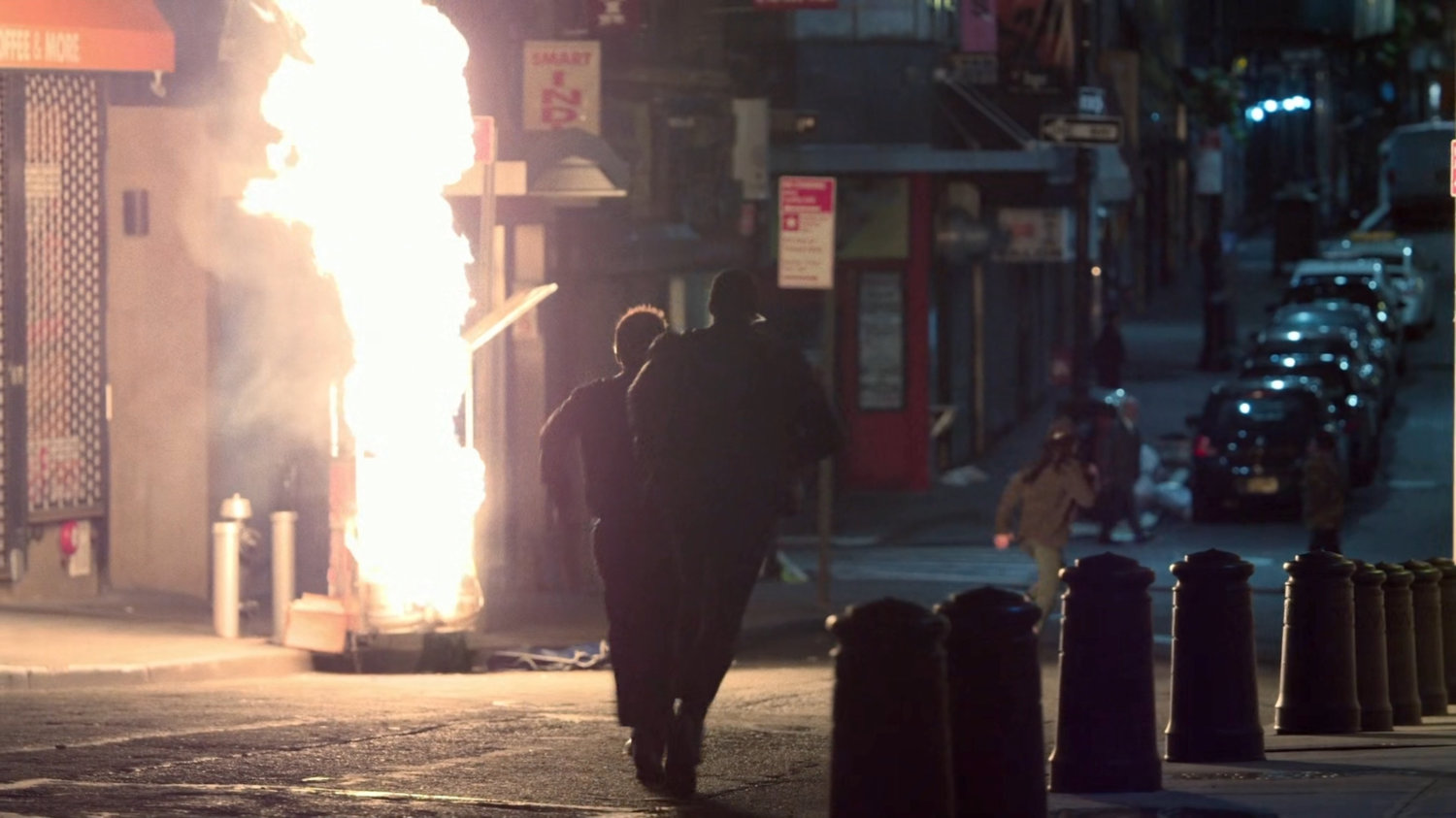 Security guards running towards an exploding peanut cart.