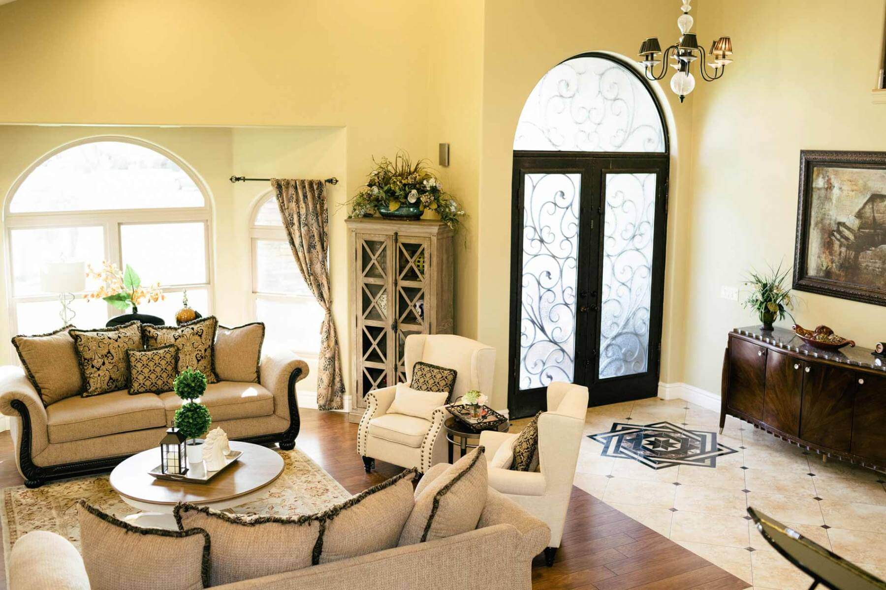 A living room with a large couches with pillows.