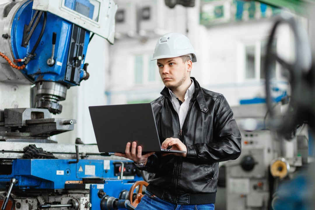 young engineer with laptop in hands