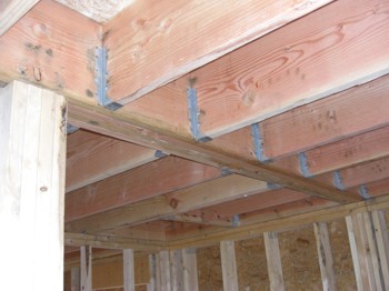 Cracks or damage to concrete ceilings indicate a problem. Wood Beam