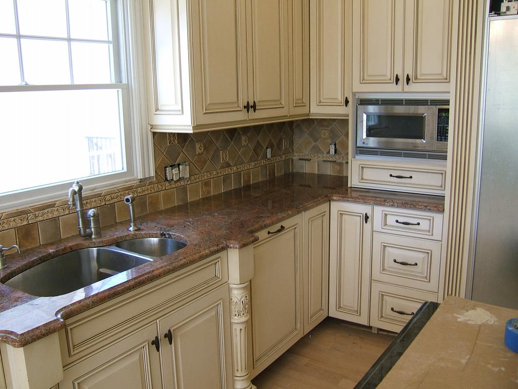 White Hand-Distressed Cabinets with Giallo Ornamental ...
