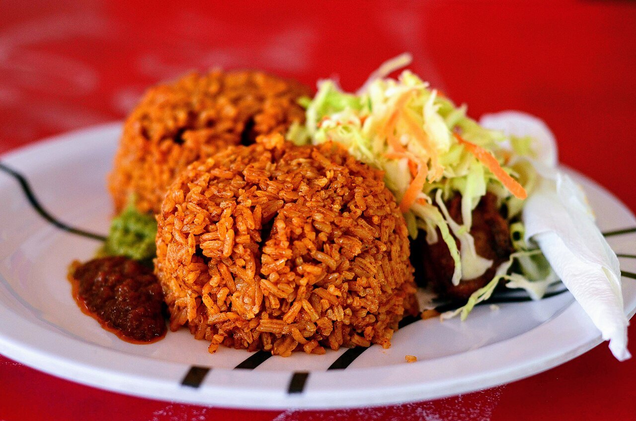Jollof rice with accompaniments.