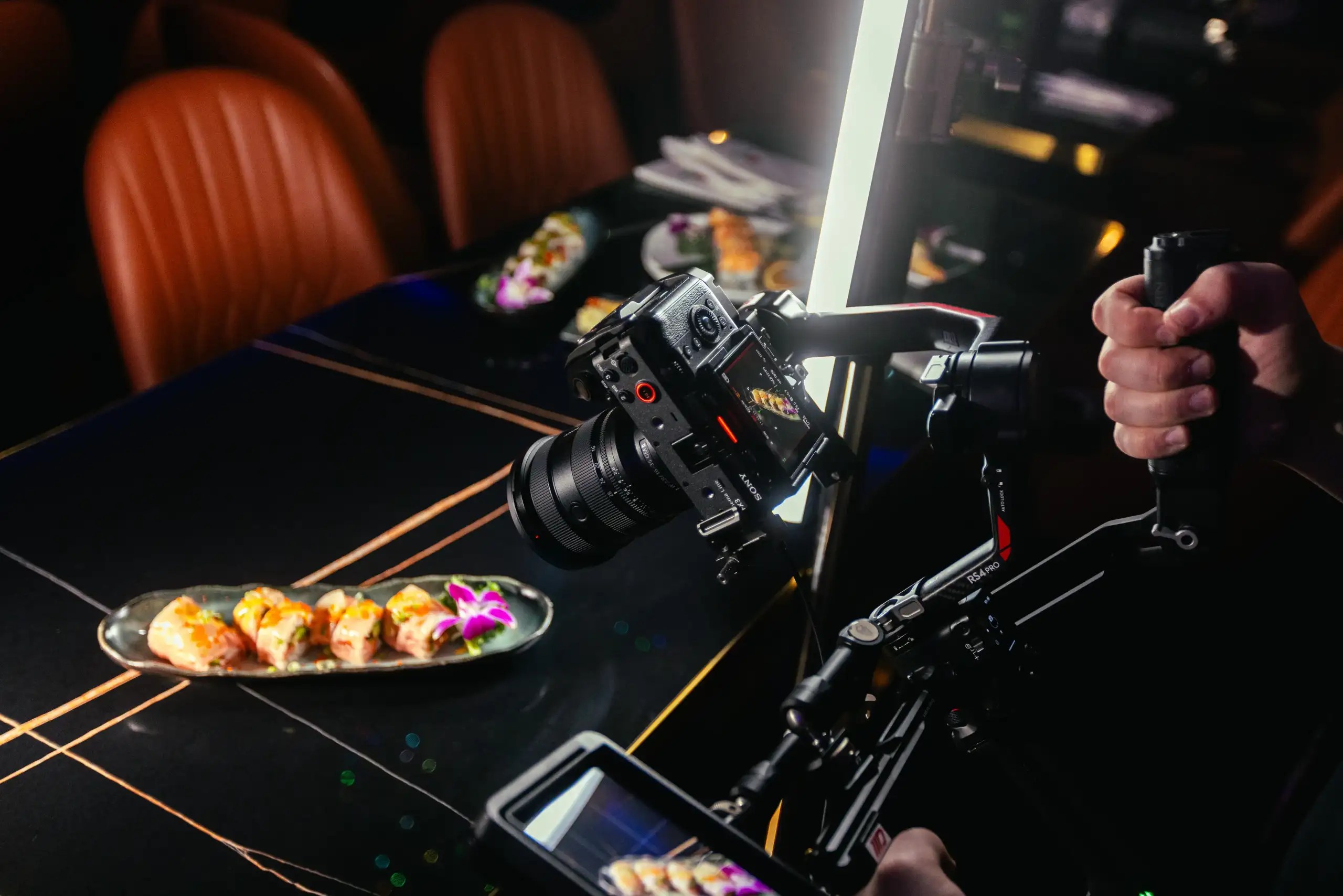 Holding a camera during a restaurant shoot