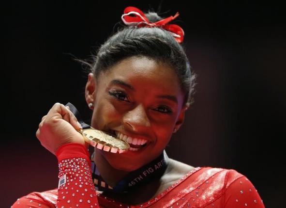 Gold medalist Simone Biles of the U.S poses with her medal after the women's all-round final at the World Gymnastics Championships at the Hydro Arena in Glasgow, Scotland, October 29, 2015. REUTERS/Phil Noble