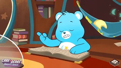 A care bear sleeping on top of a book