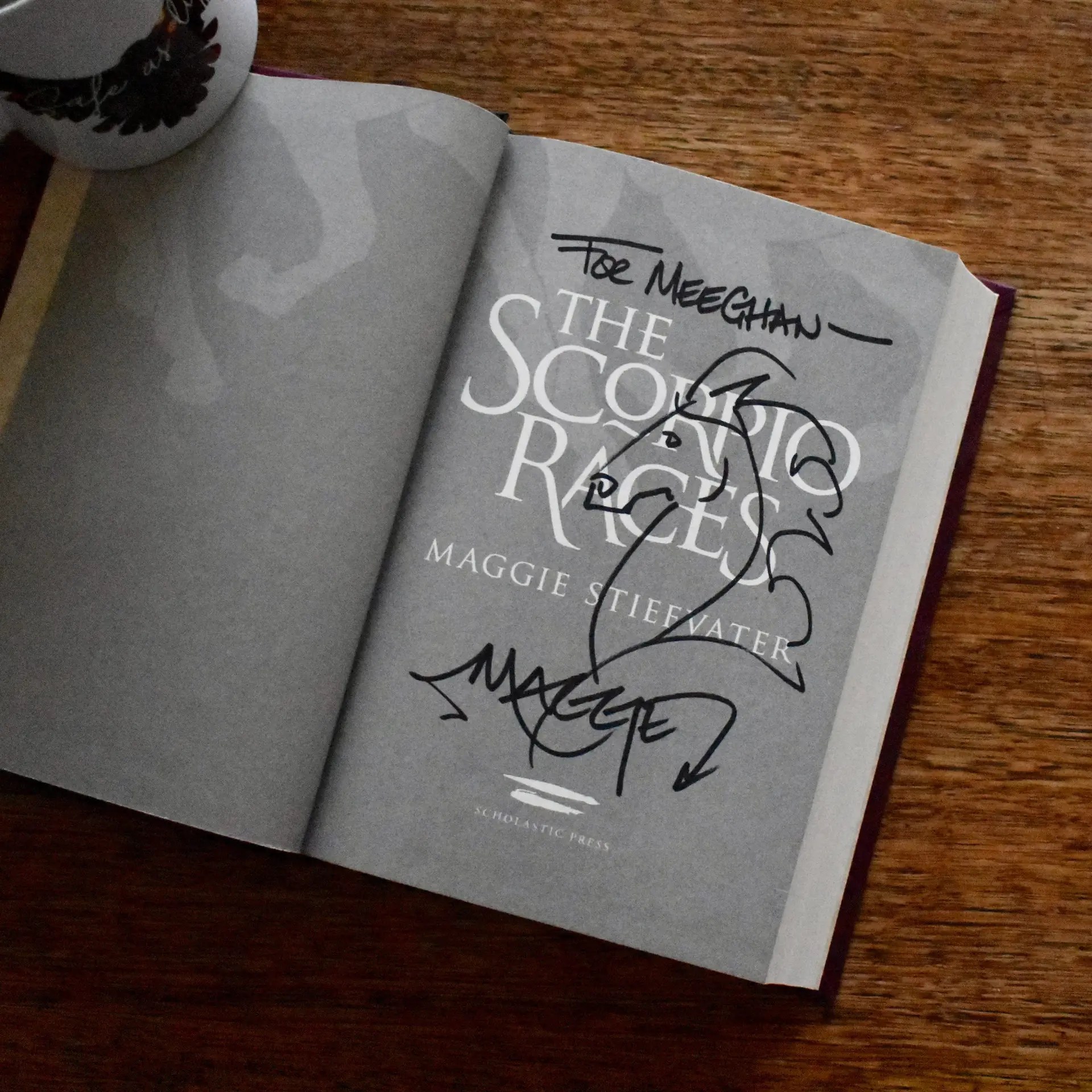 A photo of the title page of The Scorpio Races where the author has written "For Meeghan" and drawn a horse head.