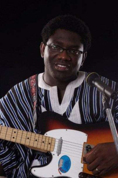 Ludare Sabada strumming his guitar