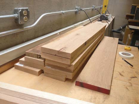 Carmine cutting down wood planks to uniform dimension.