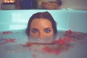 How To Build A DIY Wood Bathtub For Your Bathroom: A Step-By-Step Guide 2 woman in bathtub with red flower petals floating on water