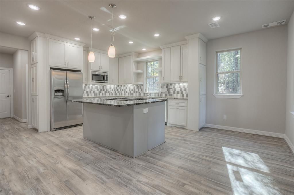Contemporary kitchen featuring smooth surfaces, integrated appliances, and minimalist design with neutral tones