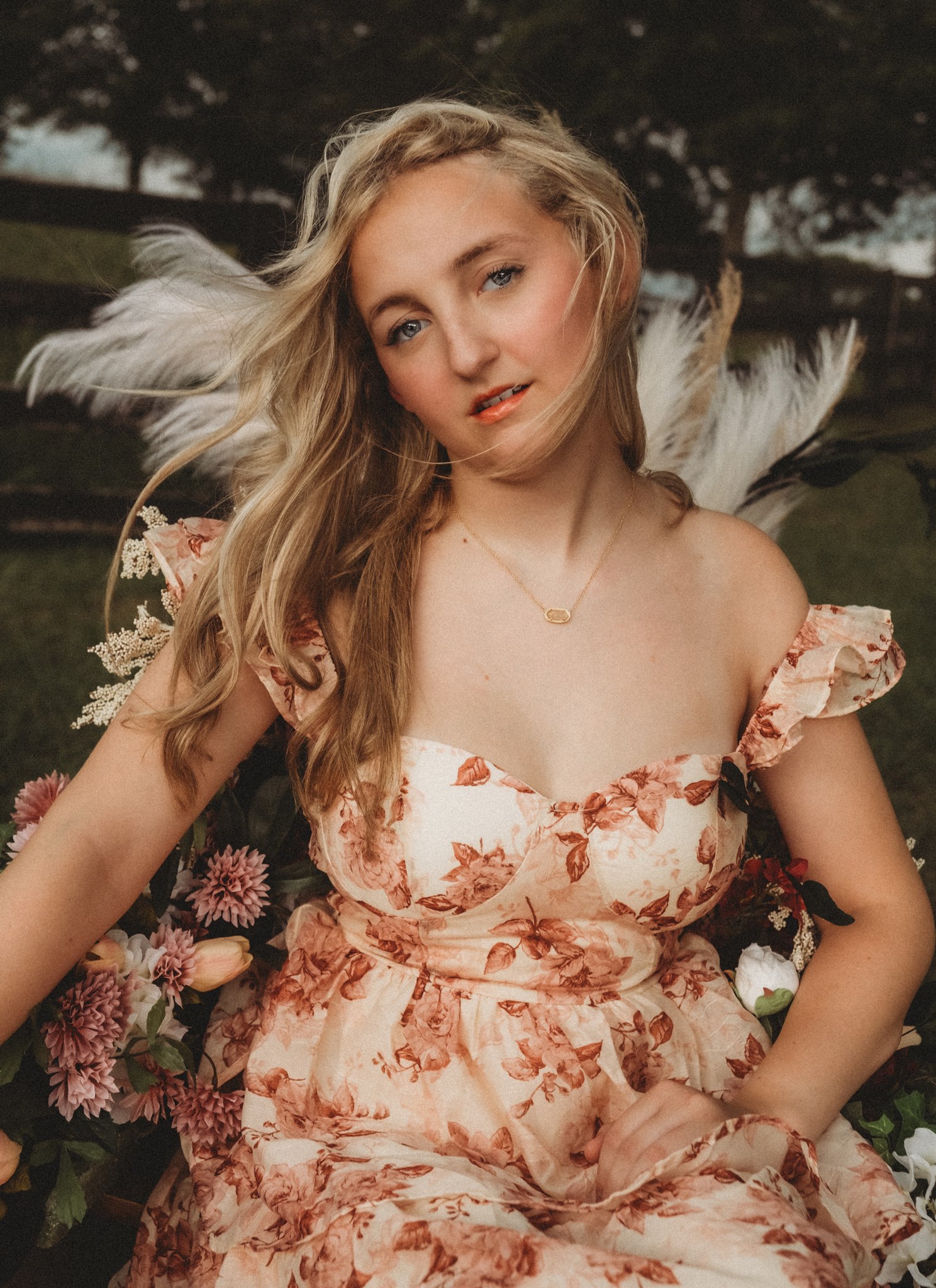 Senior session near pond, flowers & canoe