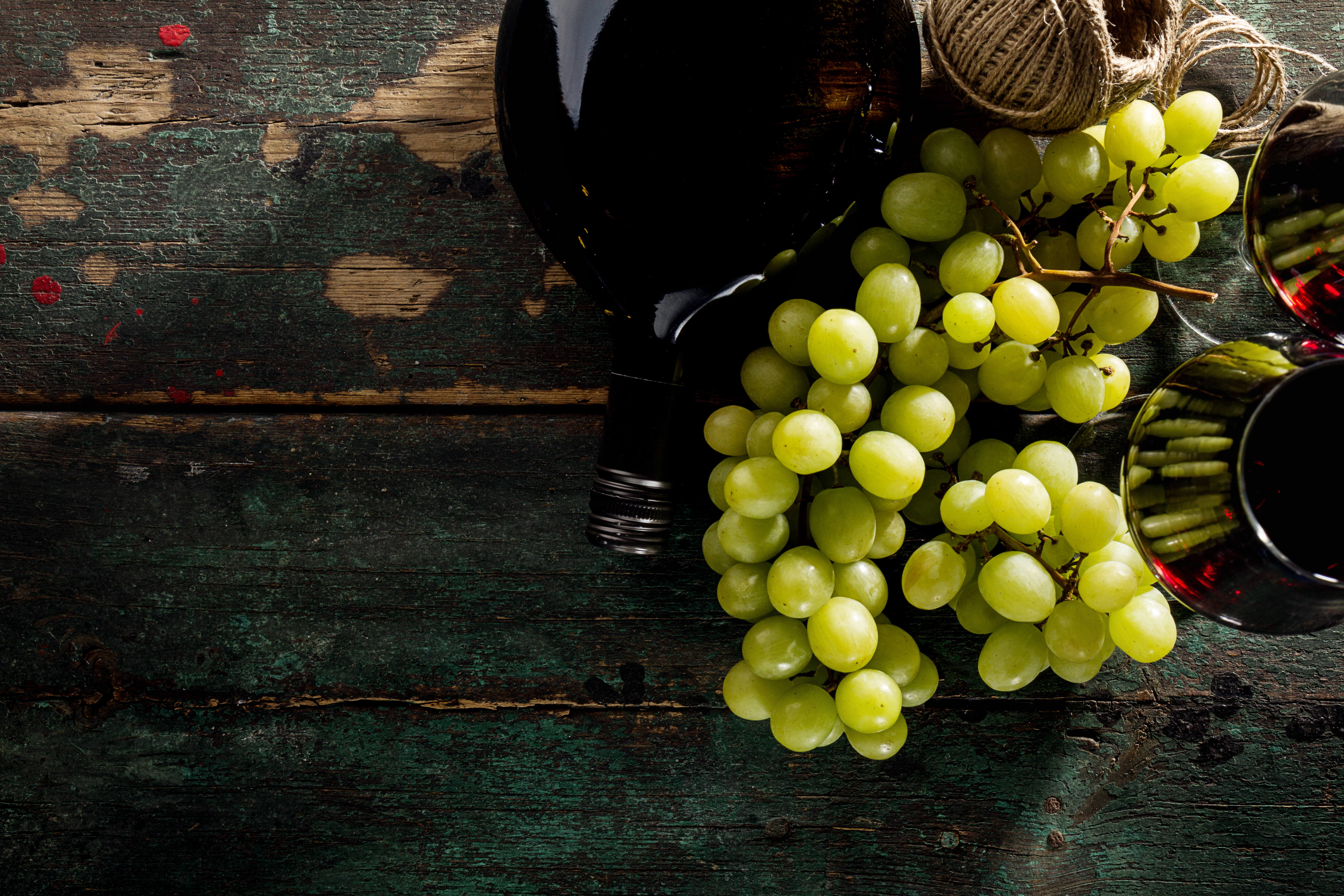 Tasty Fresh Green Grape with Wine Bottle and Wine Glass Red Wine on Old Green Vintage Background Top View Horizontal Copy Space