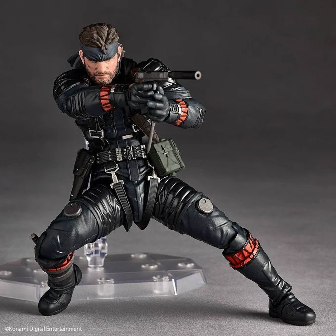 Naked Snake aiming his suppressed handgun in a low stance