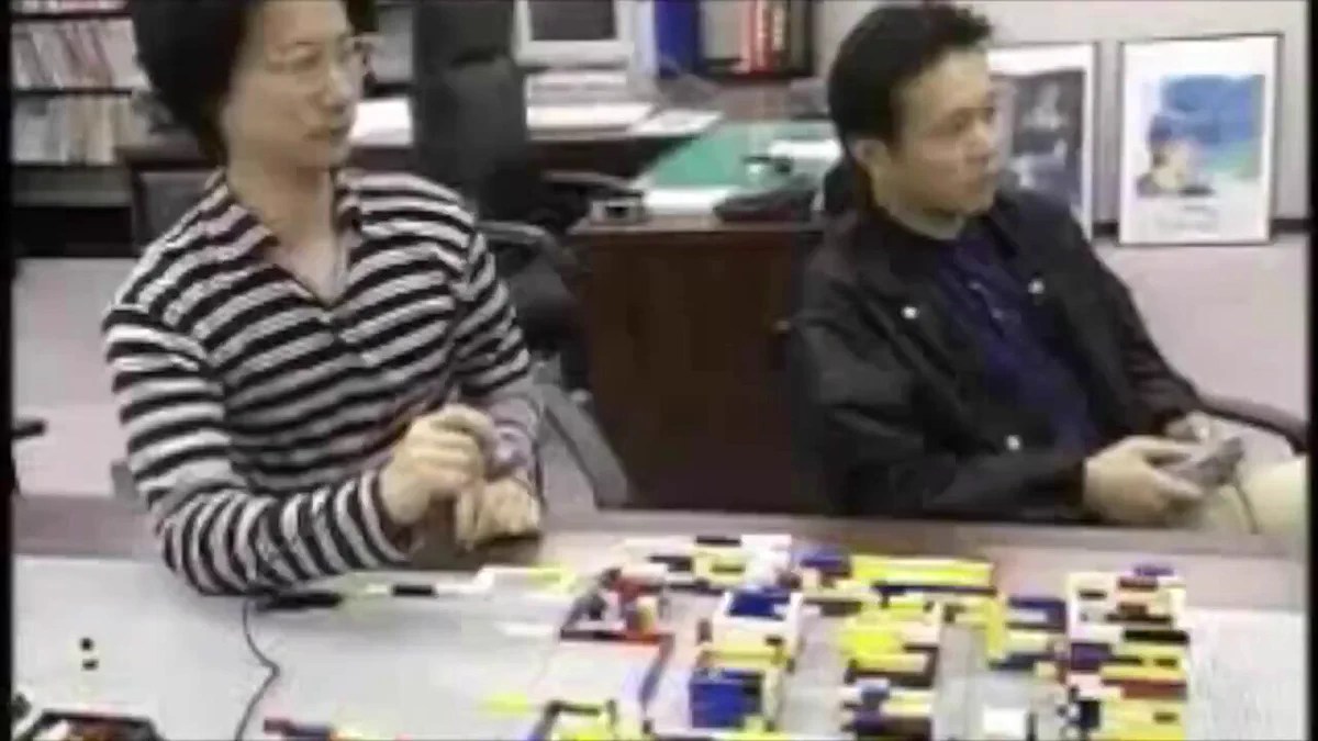 Hideo Kojima examining a LEGO model used to plan Metal Gear Solid environments