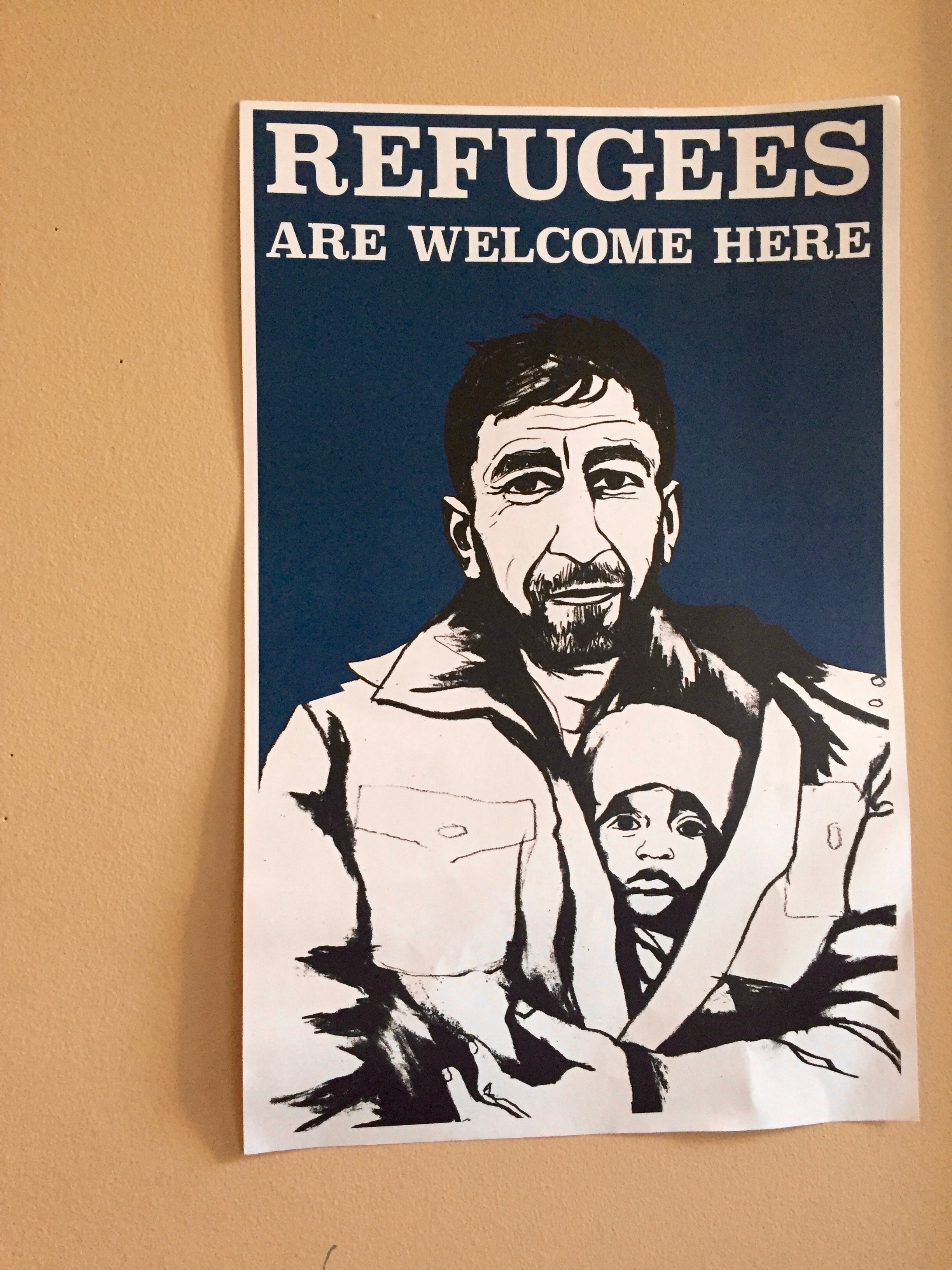 Pro-refugee fliers decorate the walls of the MIRA office.