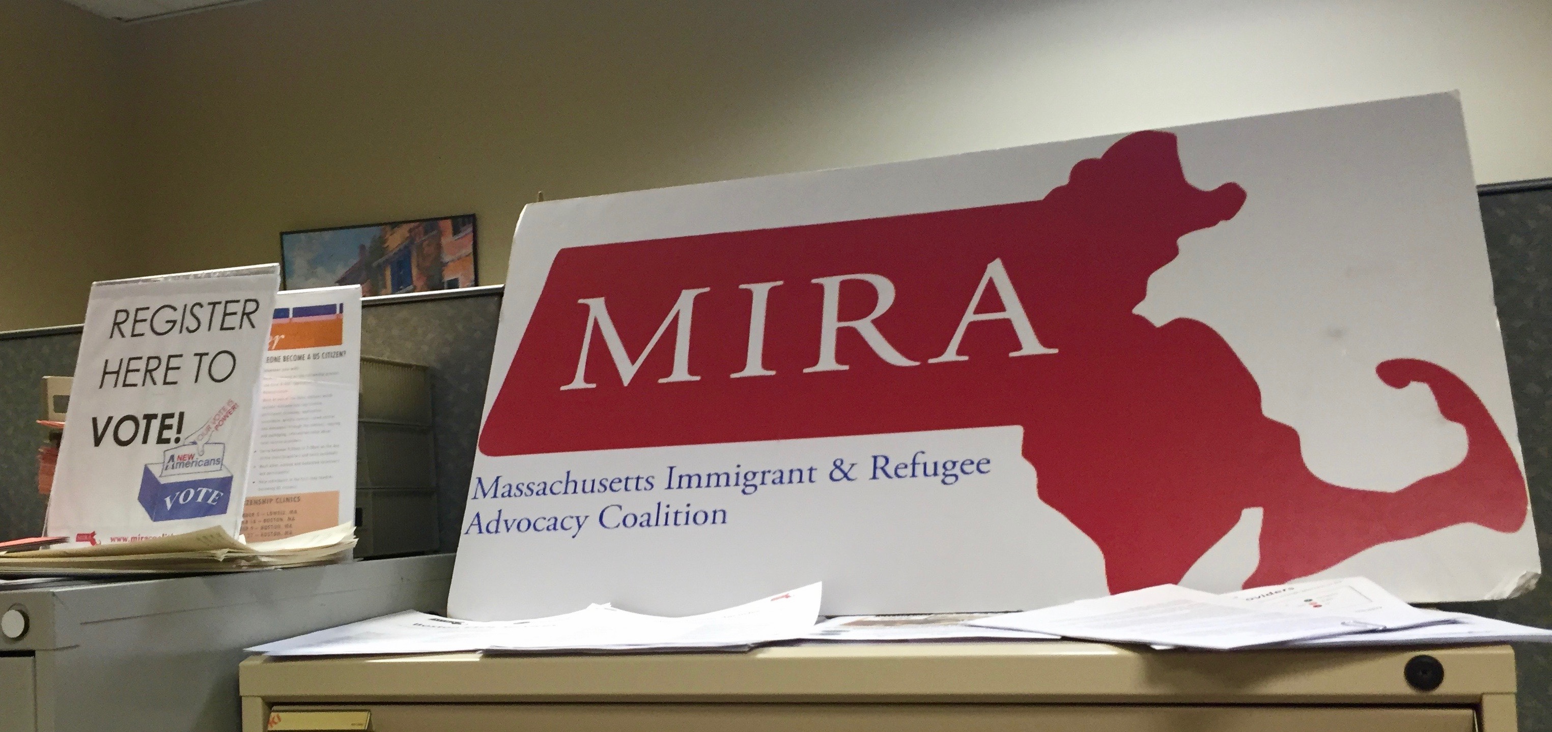 The logo for MIRA is displayed proudly next to a voter registration sign.
