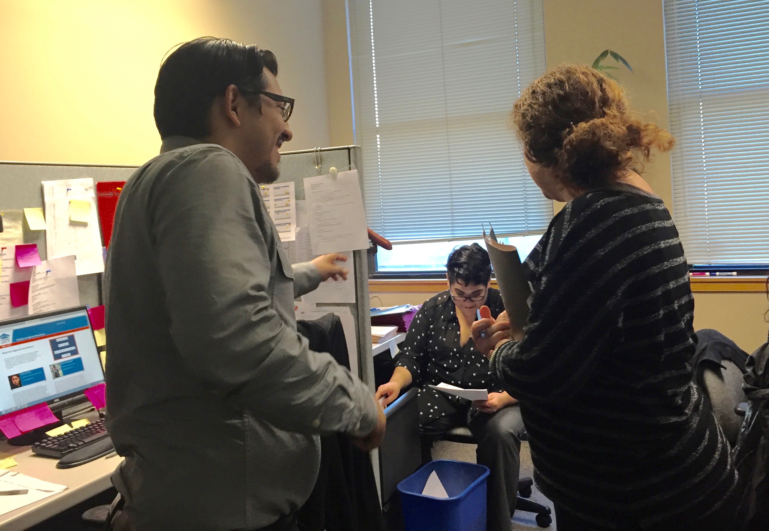 Rivera and his colleagues share a laugh in the office.