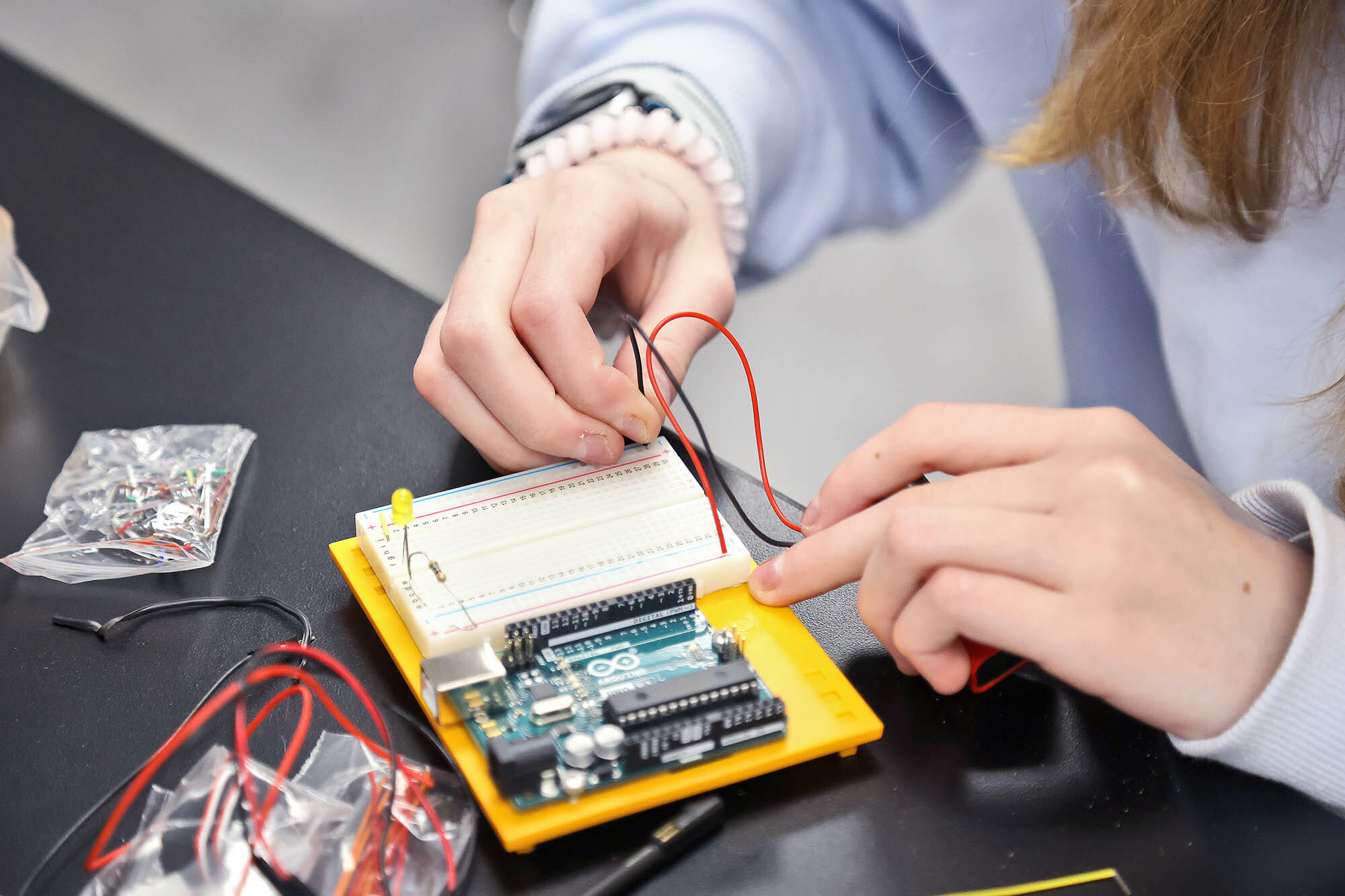 Student writing text-based code for a microcontroller project