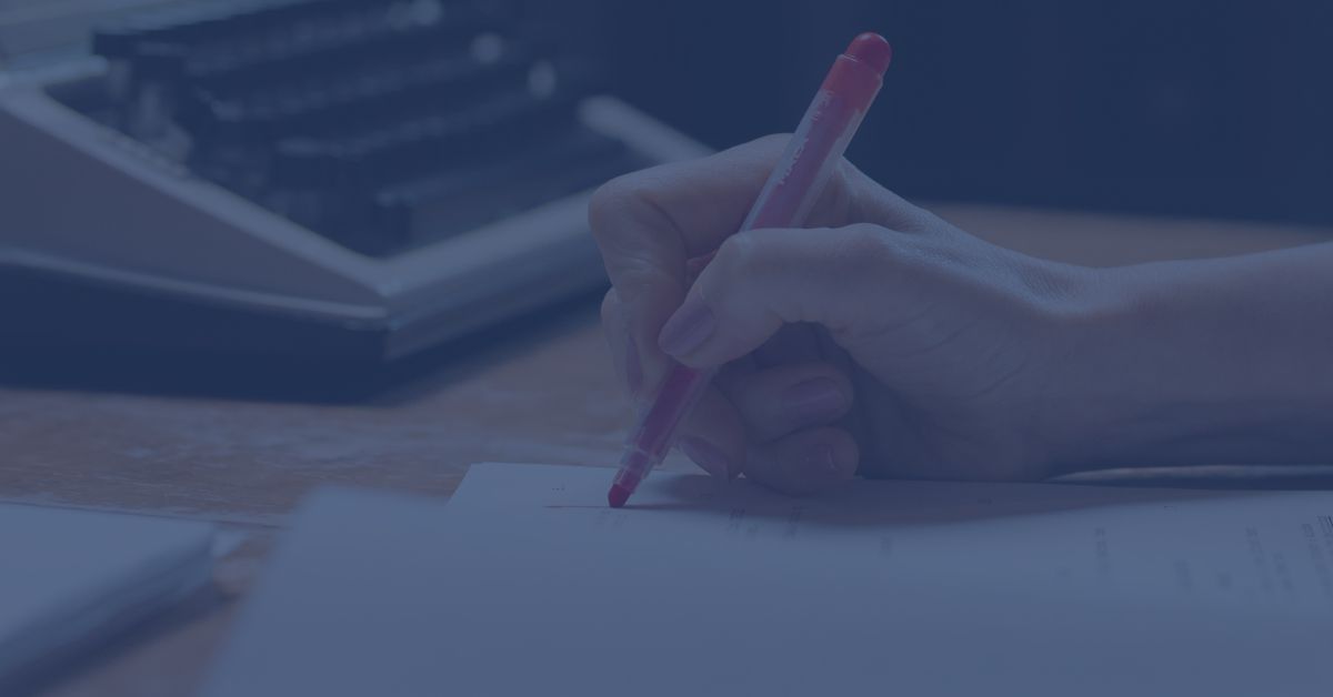woman's hand with red pen proofreading; legal transcript proofreading; legal transcript proofreader; Michelle Miller Proofreading