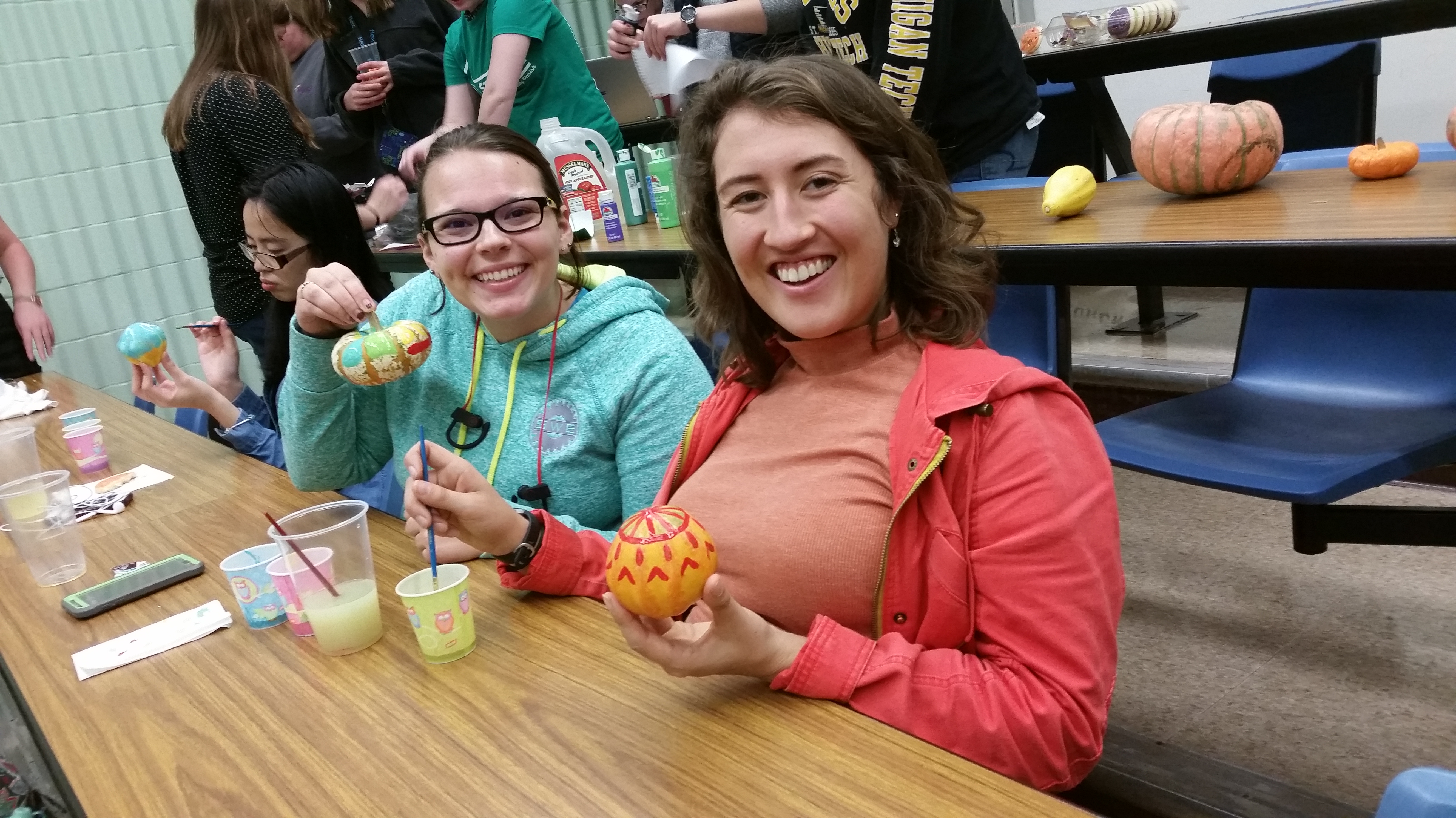 Madison and Rachel showing off their pumpkin painting skills.