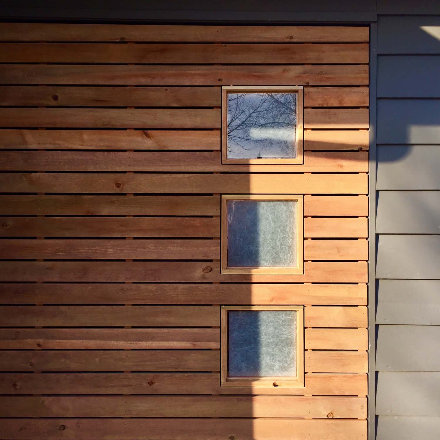 sky and photographer reflected in new windows