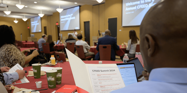 Man reading summit agenda at 2024 CFEED summit
