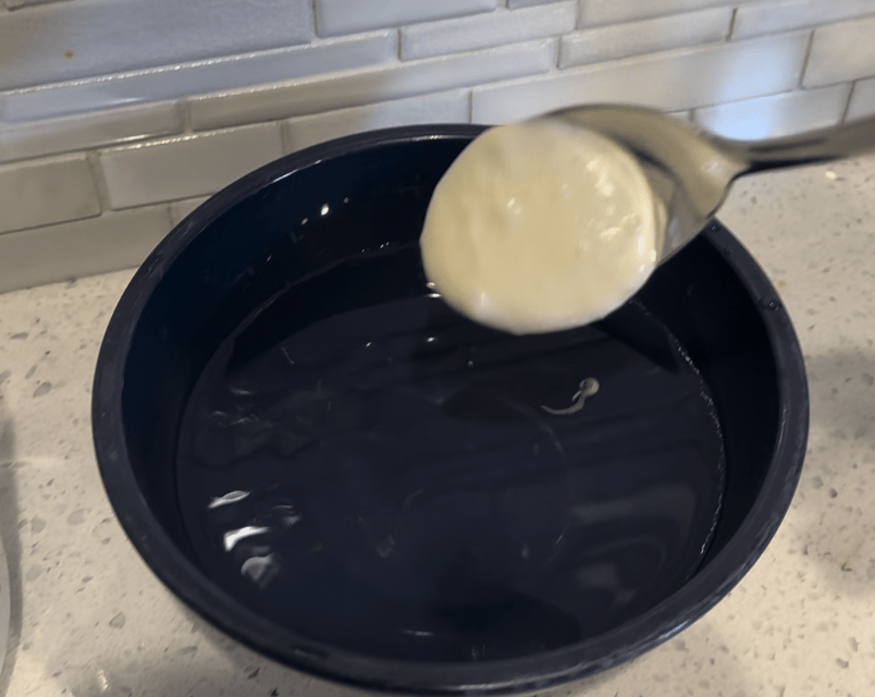 dropping spoonful of levain into bowl