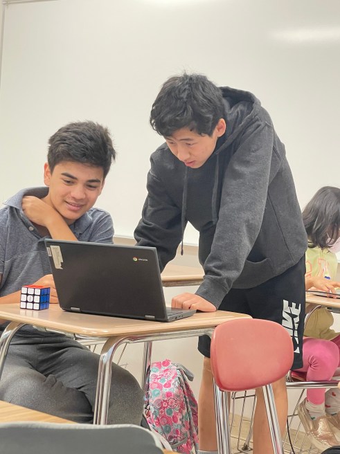 Students helping each other out of Millburn Coding Camp