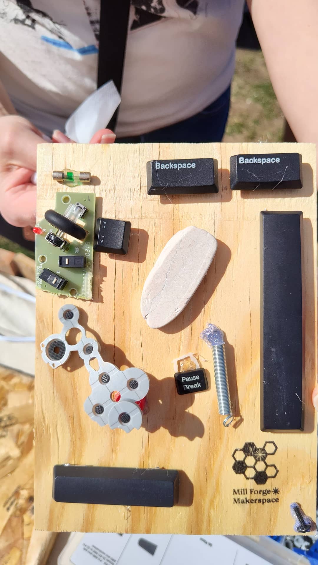 Recovered bits and bobs made into an artwork on a pine board