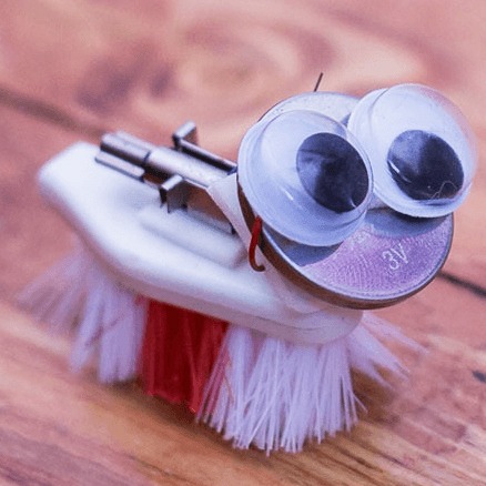 Tiny handmade bot from a toothbrush with googly eyes.