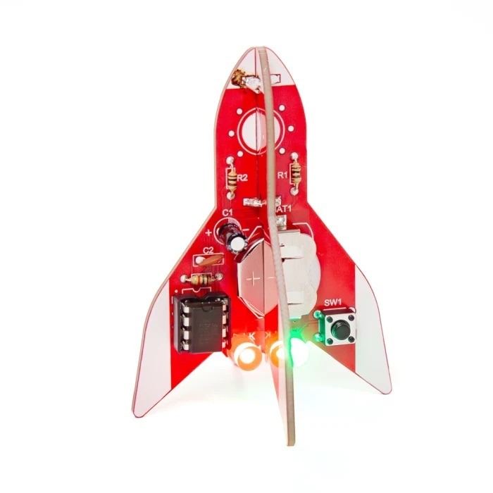 A red toy rocket made from circuit board parts