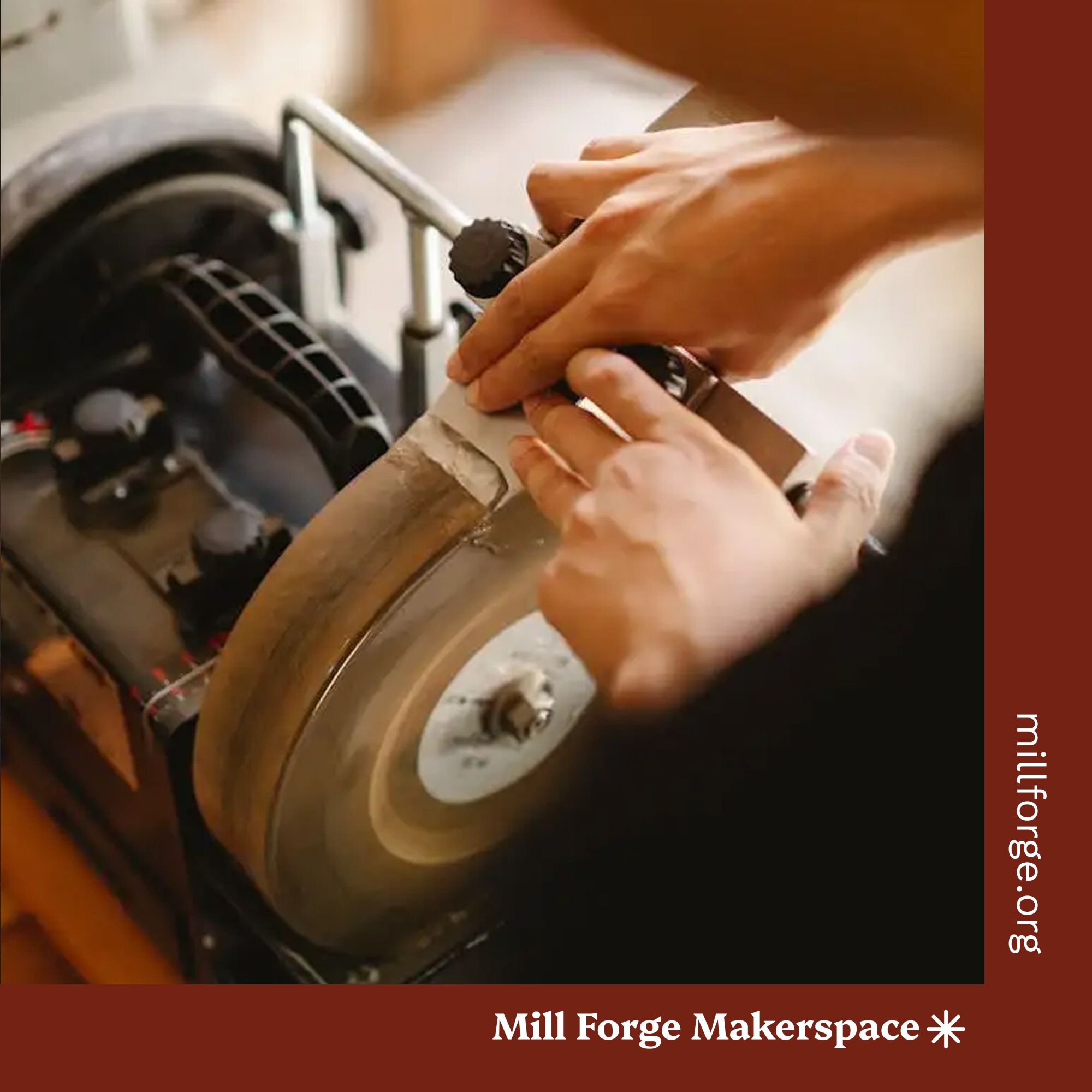 An out of focus person sharpening a metal tool on a jig.