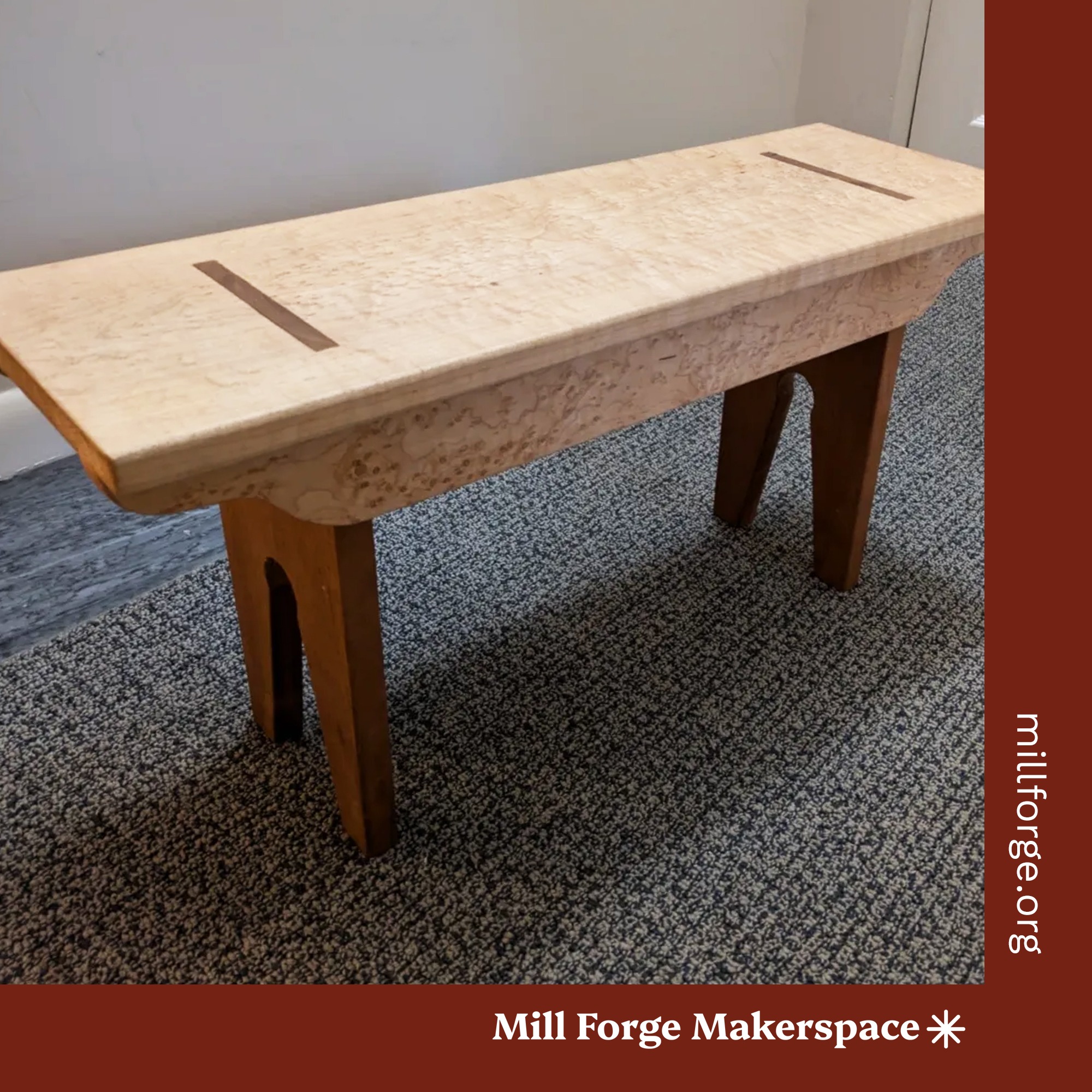 A light colored wooden shaker style bench.