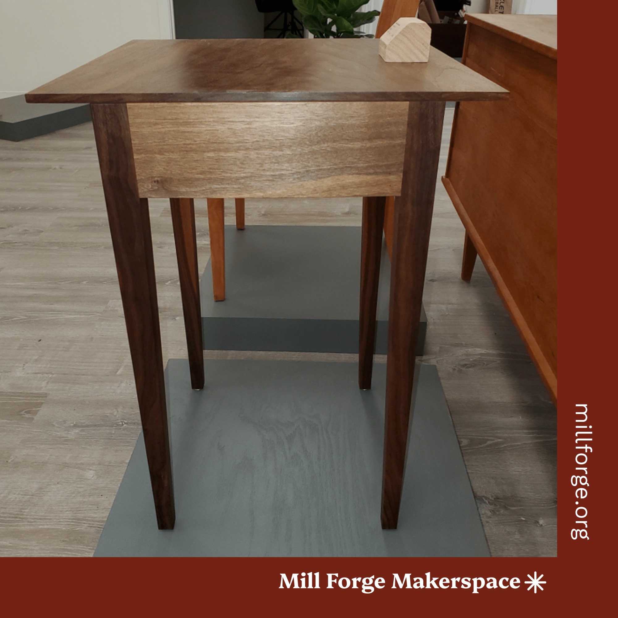 A dark wood modern style square side table.