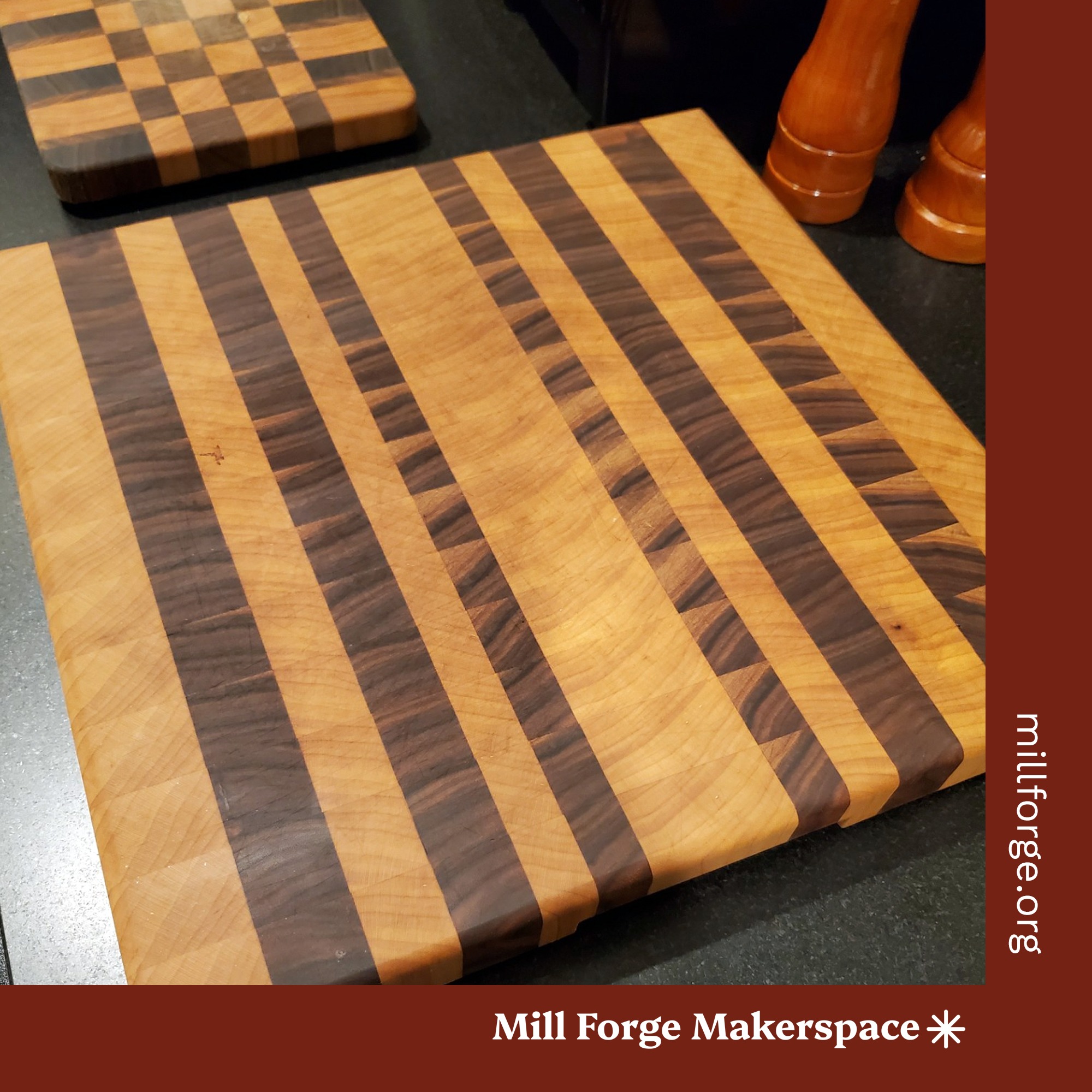 Charcuterie board made with end grain in sharply contrasting dark and light figural woods.