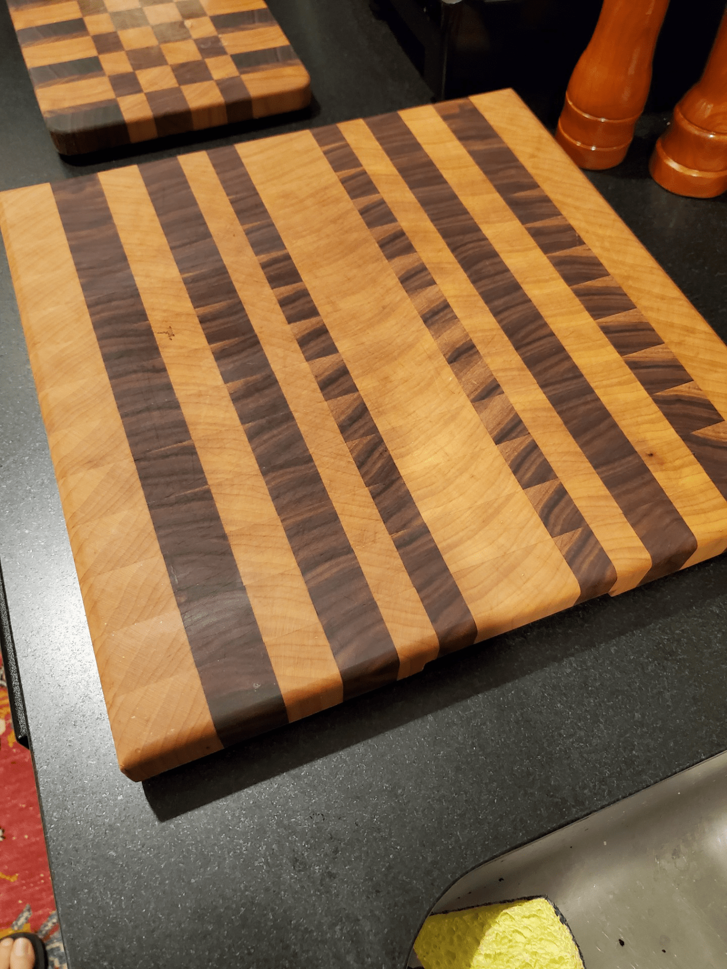 Charcuterie board made with end grain in sharply contrasting dark and light figural woods.