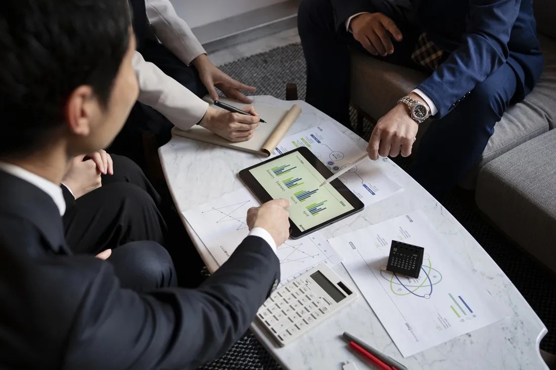 Professionals reviewing financial data and reports during a business meeting