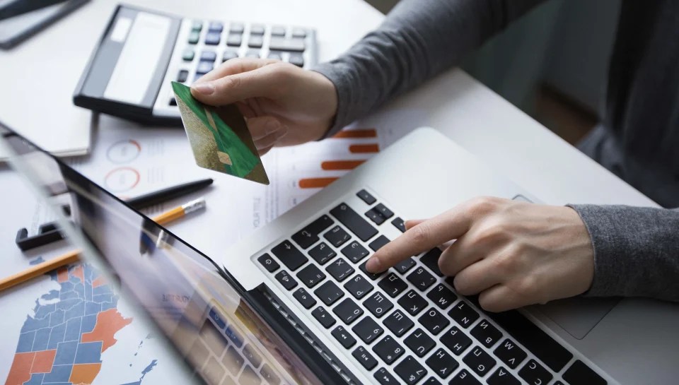 Online payment and financial reporting with laptop and credit card