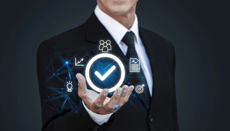 Business professional displaying compliance and quality assurance icons representing governance and performance management